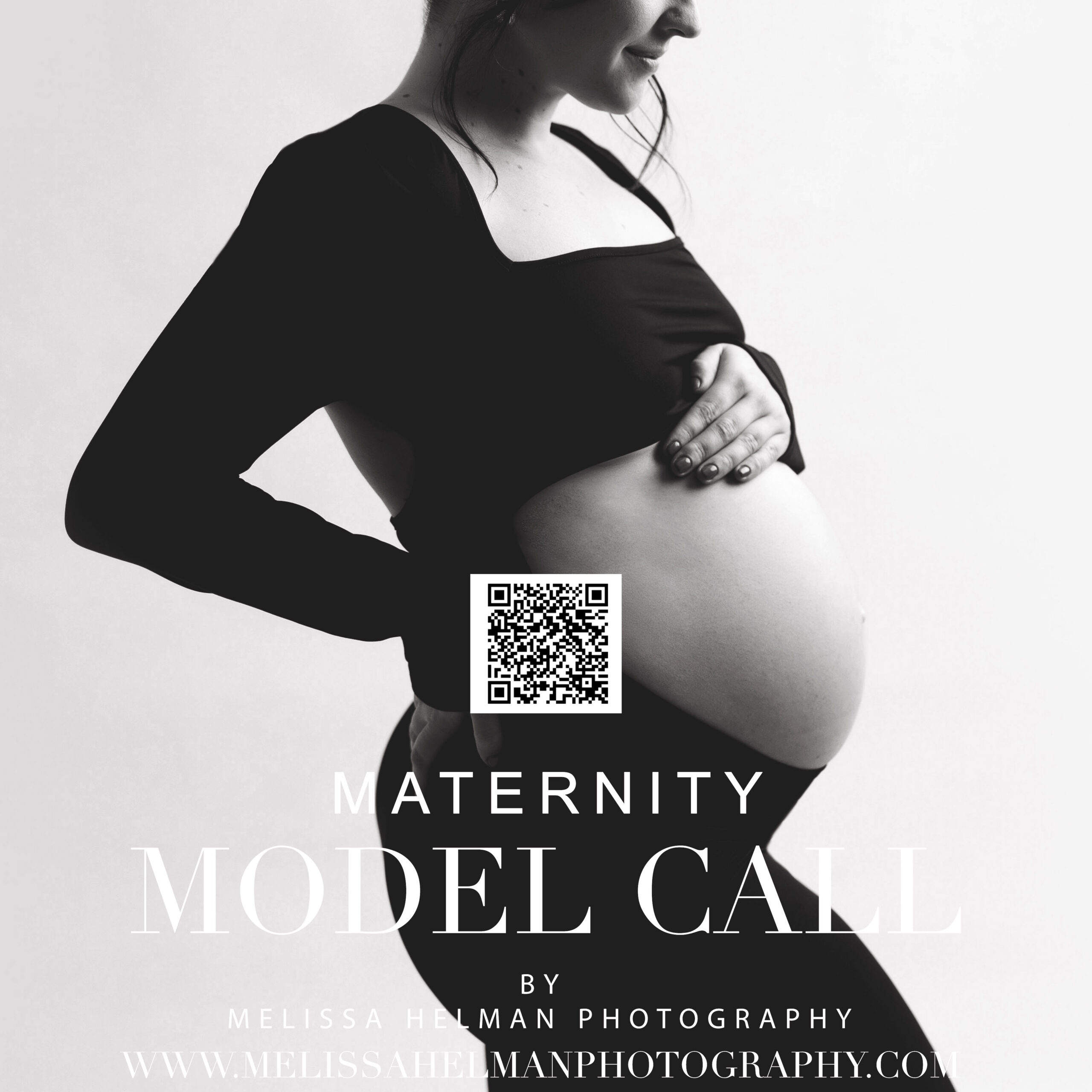 Pregnant model standing holding belly in black dress for her photography photo session in Greensburg photography studio
