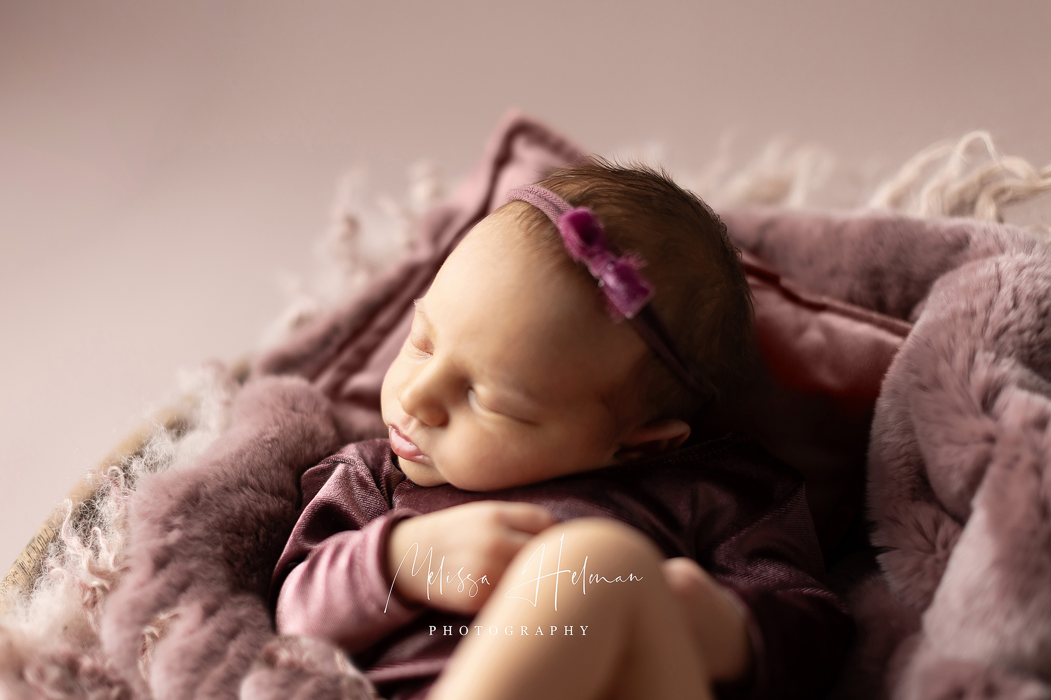 Baby sleeping in soft purple tetures
