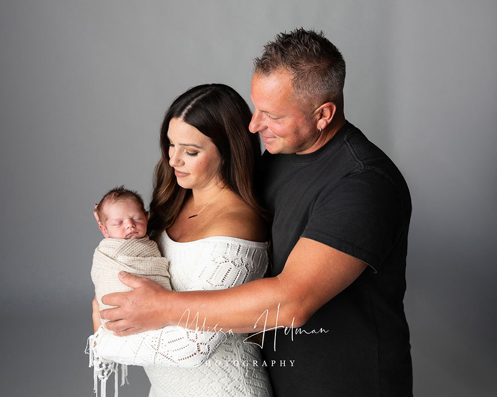 Mom and dad holding their newborn son in Pittsburgh newborn studio