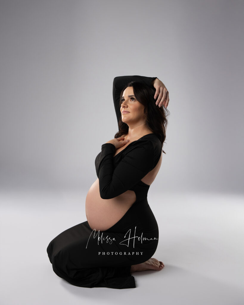 Pittsburgh mom posing while sitting with hand on heart